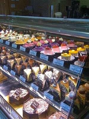 The cake case at Mozart Bakery, filled with sliced cakes and whole cakes