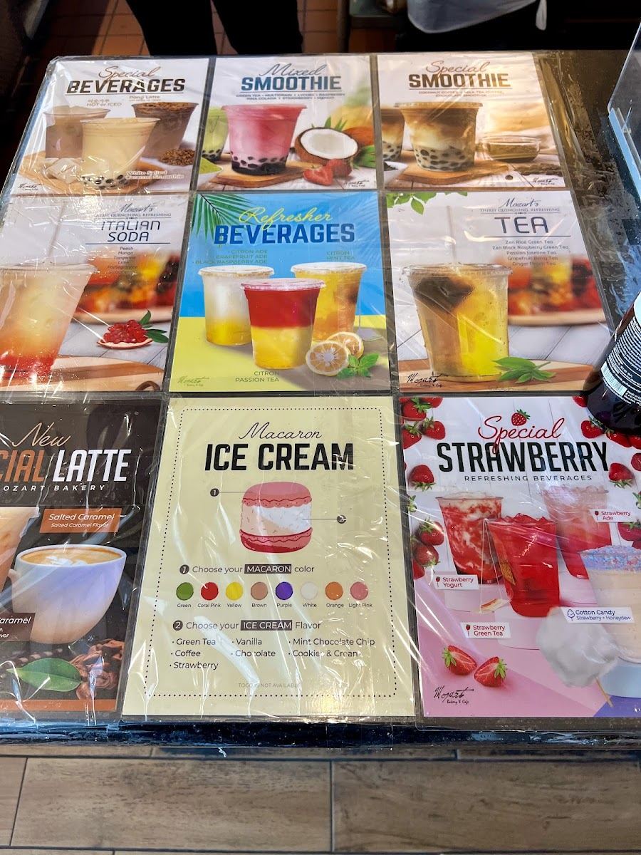 Counter menu cards showing macaron ice cream, strawberry drinks and refresher beverages