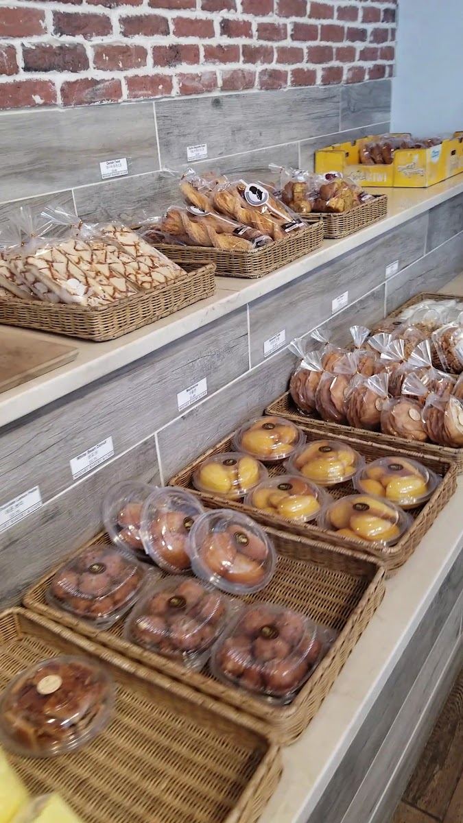 Baskets of fresh breads and pastries on the shelves at Mozart Bakery