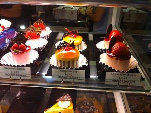 Mousse cakes in the Mozart Bakery case: raspberry, mango and strawberry