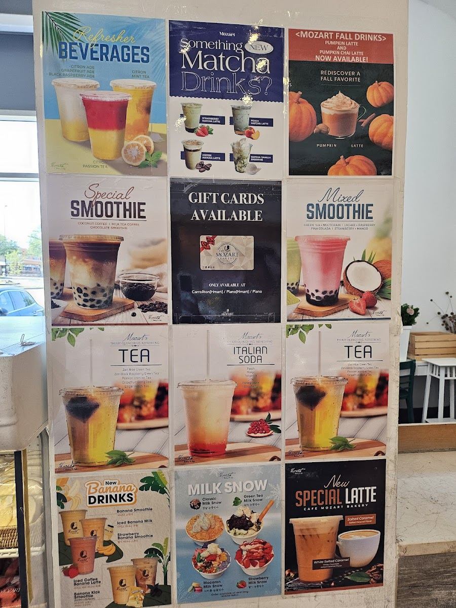 A wall of drink posters at Mozart Bakery: matcha drinks, smoothies, teas and fall pumpkin drinks